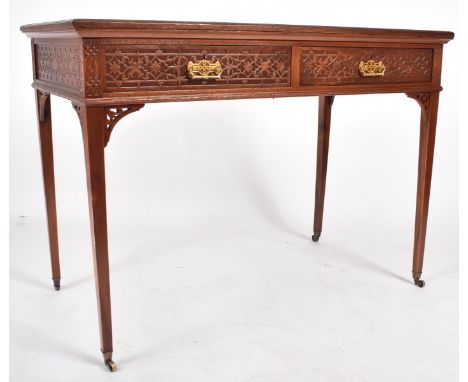 A late 19th century Victorian mahogany&nbsp;Chinese Chippendale influenced writing table desk. The desk having a burgundy lea