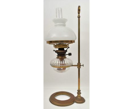 An Art Nouveau early 20th century circa 1900s brass &amp; glass desk oil lamp light. The lamp having a brass skeleton with ri