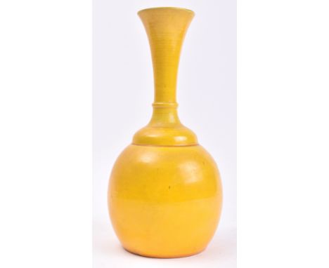 An early 20th century Chinese Oriental believed Qing Dynasty ceramic yellow glaze bottle vase. The vase having a trumpet flar