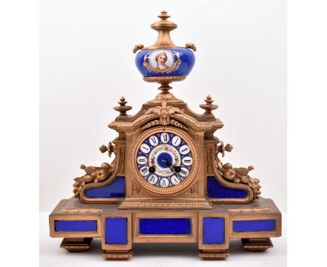 A 19th century French gilt brass and enamel porcelain painted mantel clock. The clock inset with Sevres manner porcelain pain