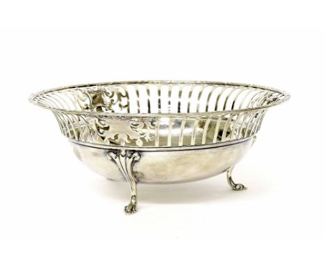 George V circular silver basket with a pierced rim upon three scroll feet, maker James Dixon & Son,  Sheffield 1916, 7.75" di