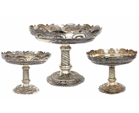 Late Victorian silver comport table garniture, with card-cut rims with shell motifs, over embossed foliate garlands on wrythe