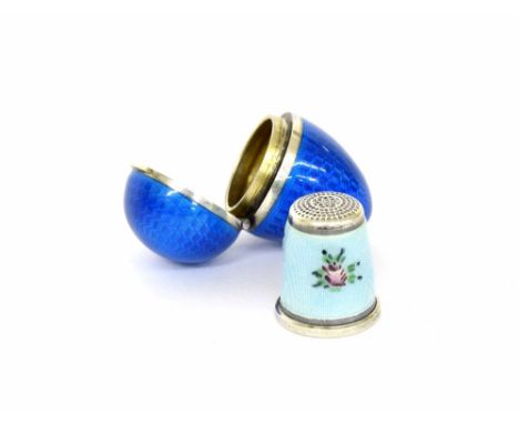 Sterling silver and blue guilloche enamel egg shaped thimble case, 1.5"; containing a silver and pale blue enamel floral desi