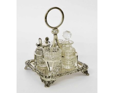 Edwardian silver cruet set, with cut glass condiments on a square base with cast foliate and gadrooned border, maker The Alex