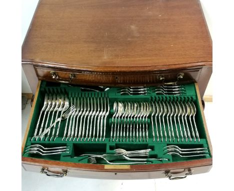 Cooper Bros A1 silver plated 12 place setting canteen of kings pattern cutlery in a mahogany 2 drawer table cabinet on cabrio