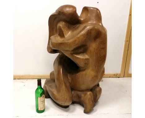 Large scale wooden sculpture of a kiss monogrammed E M B dated 1974 - 85cm high x 50cm across