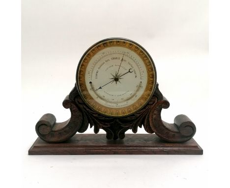 Antique aneroid barometer with curved thermometer on hand carved oak stand - 21cm high x 32cm wide x 7cm deep