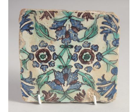 AN 18TH CENTURY NORTH AFRICAN TUNISIAN GLAZED POTTERY TILE, painted with floral motif. 15cm square