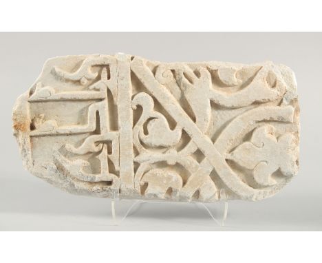 A FINE LARGE 11TH/12TH CENTURY PERSIAN SELJUK CARVED MARBLE TILE, with Kufic calligraphy and arabesque decoration, 43cm x 22c