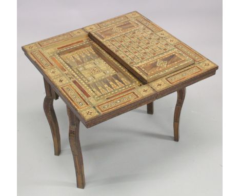 A LATE 19TH - EARLY 20TH CENTURY INDIAN PARQUETRY LOW GAMES TABLE, with folding and swivelling rectangular top revealing a fu