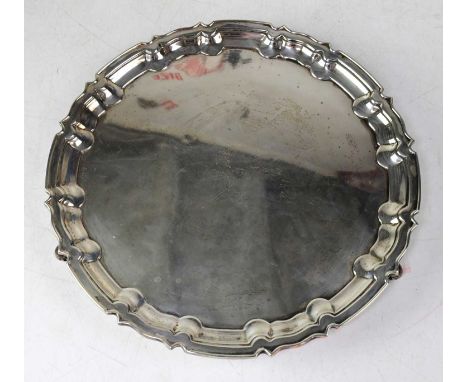 WILLIAM HUTTON &amp; SONS LTD; an Edwardian hallmarked silver salver of circular form, raised on three scrolling supports, Lo