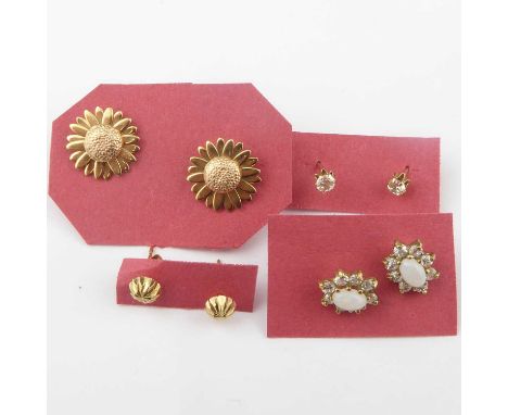 Four pairs of 9ct gold stud earrings comprising a pair of sunflower design, star cut tiny studs, white stone studs and opal a