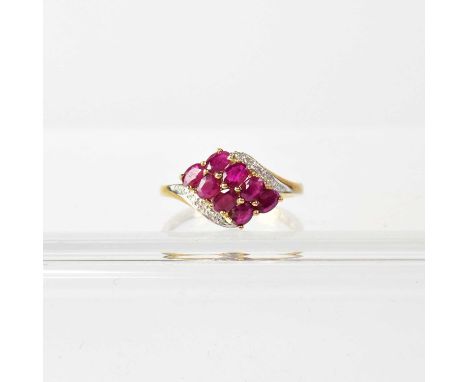 A 9ct yellow gold dress ring, set with eight rubies and small diamond chips, size Q, approx. 2.6g.