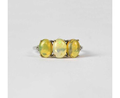 A 9ct white gold dress ring set with three jelly opals and diamond chips, size S, approx. 2g.