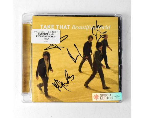 TAKE THAT; a 'Beautiful World' CD bearing the signatures of the four band members at the time.Condition Report: We have not a