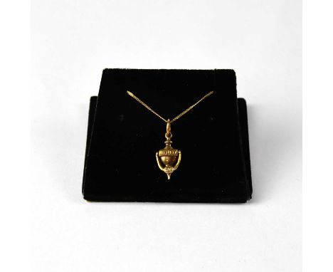 A 9ct yellow gold fine link chain with a 9ct yellow gold door knocker pendant, approx. 1.7g.