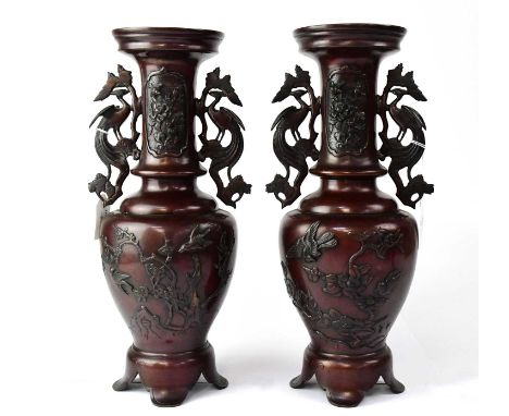 A pair of Japanese Meiji period bronzed twin-handled vases relief decorated with birds amongst branches and with stylised bir