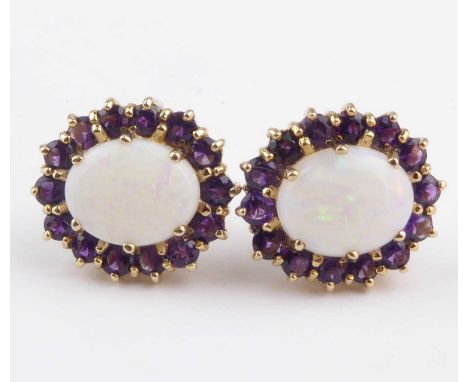 A pair of 9ct gold opal and amethyst earrings, the central claw set large white opal with traces of green red and blue, withi