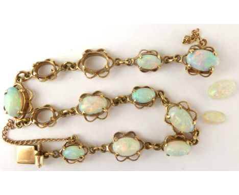 A 9ct gold and opal bracelet, the dainty bracelet with twelve mounted oval white opals, with flashes of green and blue, unite