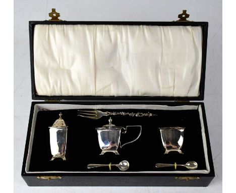 A cased white metal three-piece cruet set, simply stamped 'Silver', with blue glass liners, two associated hallmarked silver 