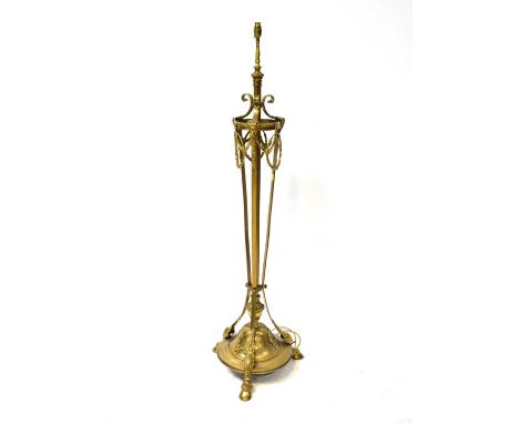 An Edwardian brass standard lamp of Neo-Classical design, with telescopic column, raised on goat mask and hoof feet, height 1