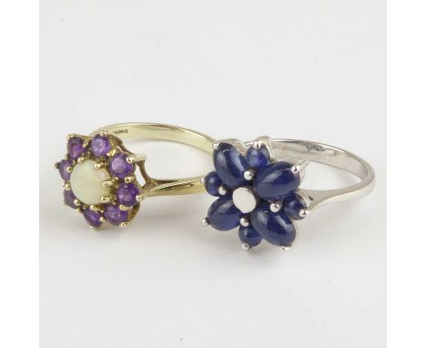 Two 9ct white gold flower cluster rings, comprising an example with central white opal surrounded by eight claw set amethyst 