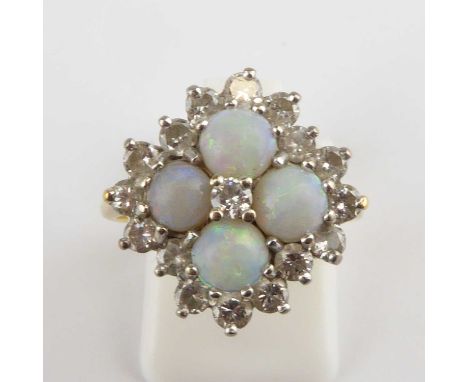 An 18ct gold opal and diamond cluster ring, the central prong set diamond approx. 0.07ct, nestled between four white opal cab