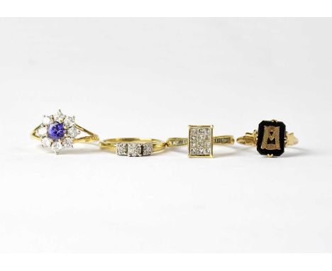 Four 9ct yellow gold rings comprising a floral set ring with central amethyst and white stone surround, size N, an onyx and g