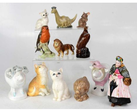 A collection of ceramic animals and figures comprising a Crown Derby figure of an old lady (af), Beswick birds, Loch Ness Mon