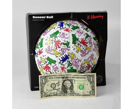 KEITH HARING; a US $1 bill bearing the artist's signature, 'Dog' doodle and with love heart to George Washington image, in bl