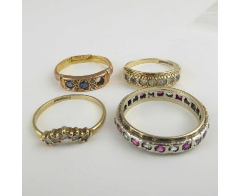 Four 9ct gold dress rings, comprising a wishbone example with white stones, size L, a rose gold and sapphire example (one sto