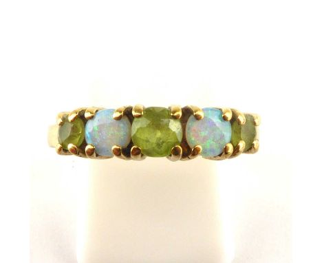 A 9ct gold opal and green stone ring, with three graduated cut claw set green stones separated by two claw set round opals, w