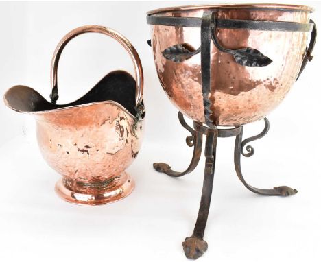 A 19th century copper and wrought iron planter, the dome-shaped copper planter nestling in a wrought iron frame with leaves a
