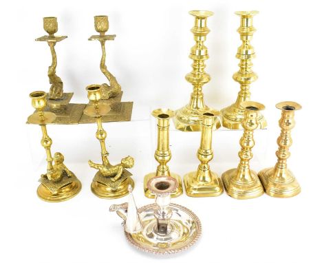 Five pairs of vintage and antique brass candlesticks, to include a pair with dolphin stem and square stepped base, height 21c