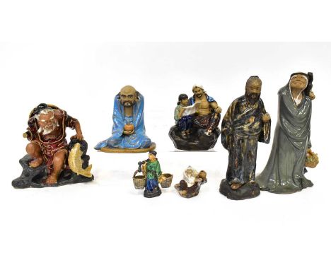 Six ceramic Oriental figures of varying forms and sizes, to include a seated fisherman with leaping fish, a young father and 