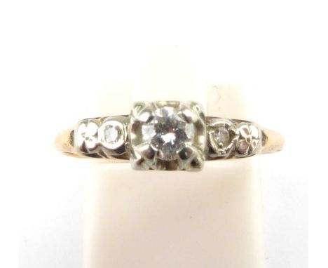 An 18ct gold diamond ring, the principal claw set brilliant cut diamond flanked by two illusion set brilliant cut diamonds, s