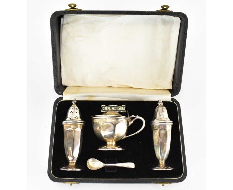 An Elizabeth II hallmarked silver four-piece cased cruet set, comprising salt, pepper, mustard pot with blue glass liner and 