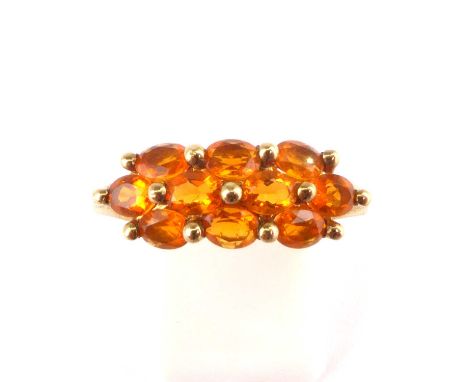 A 9ct gold cluster ring set with orange gemstones, size R, approx. 2.3g.