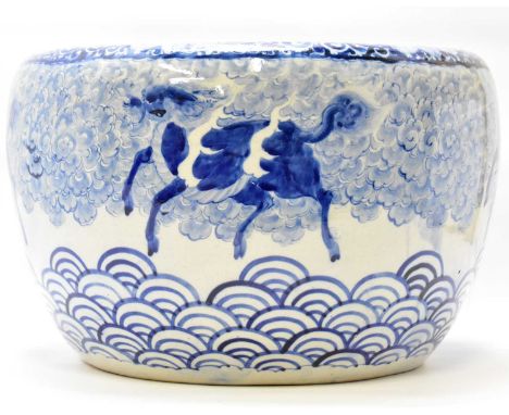 A mid-20th century large Chinese blue and white painted planter decorated with dragon dogs in clouds, with a floral border to
