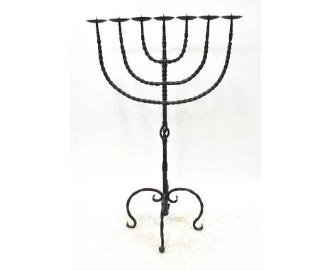 A large wrought iron pricket candlestick with pierced column and four scrolling supports, height 151cm.