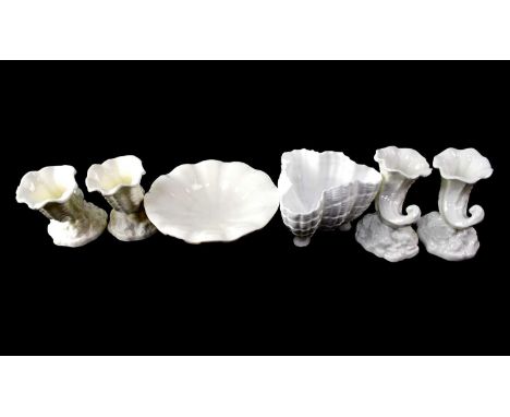 ROYAL WORCESTER; six blanc de Chine items comprising four small cornucopias on naturalistic rocky bases, with green back stam
