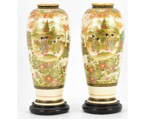 A pair of 19th century Satsuma vases of ovoid form, each with panel of geishas with pagoda and mountains to the background an