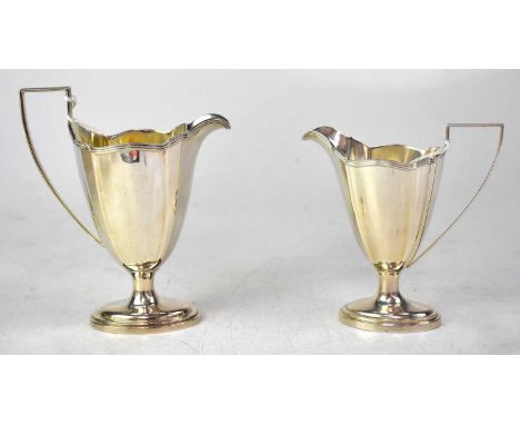 GORHAM; two silver milk or cream jugs of stylised oval form, with Art Deco reeded handles, on domed oval feet, maker's marks,