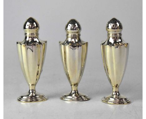 GORHAM; three American silver pepperettes of fluted tapering form, on stepped oval bases, height 12.5cm, maker's mark, stampe