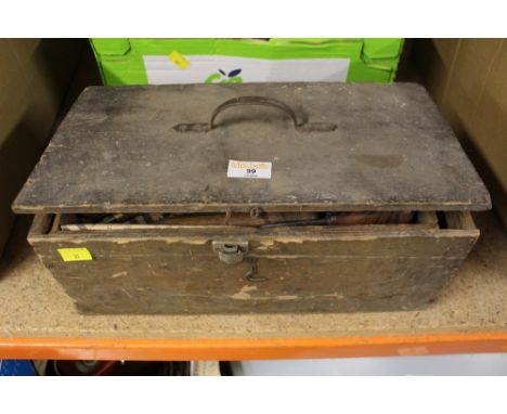 A wooden tool chest containing hand carving tools  