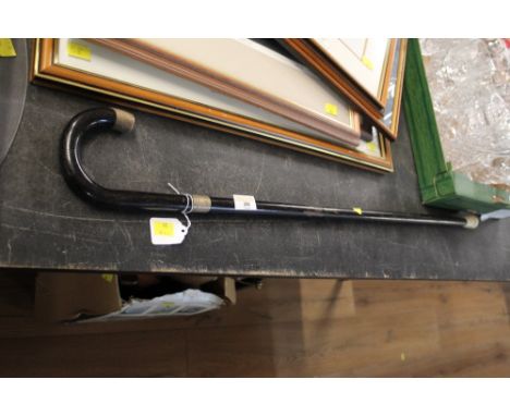 An ebonised walking stick with Chester silver collar 