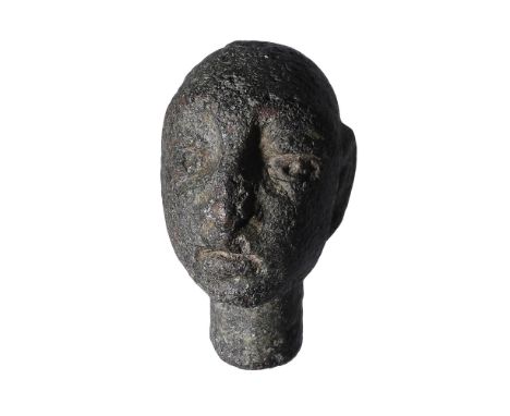 Celtic, bronze pin head, 1st century AD, 1.8cm by 1cm; moulded in the round with a stud below for attachment; male head with 