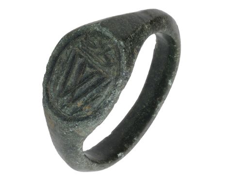15th century, a bronze seal ring, 2.8cm diameter, octagonal shaped bezel with a grooved line border enclosing a crowned W fla