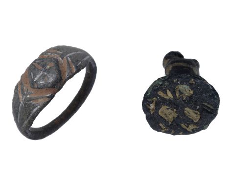 Romano-British, tinned-bronze finger ring, 3rd century AD, raised lozenge-shaped bezel incised with a cross motif, 1.9cm diam