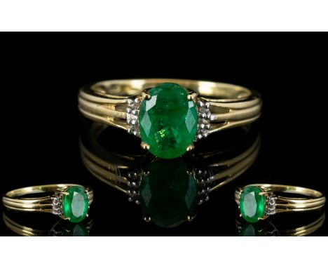 A 9ct Yellow Gold And Emerald Ring Wonderful oval cut solitaire ring, the reeded shoulders surrounded by 8 faceted zircons, f